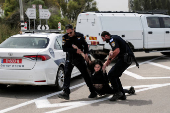 Israeli police detain a protester during a demonstration by Israeli and American Rabbis as they block a road while they gather to symbolically bring food to Gaza, near Erez crossing
