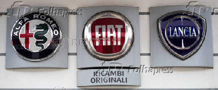 Logos of Alfa Romeo, Fiat and Lancia are displayed outside a car dealership