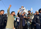 People gather as they celebrate, after Syrian rebels announced that they have ousted President Bashar al-Assad, in Tripoli