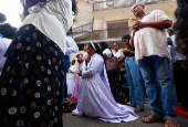 A Catholic nun prays during the Holy Friday Passion of the Lord Celebrations on a road in Colombo