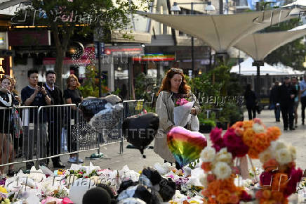 Floral tributes are left for victims of the attack at Westfield Bondi Junction shopping centre in Sydney