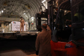 Emirati military personnel direct a Lebanese forklift driver while unloading palettes at Beirut International Airport