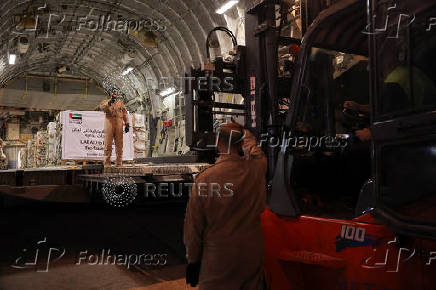 Emirati military personnel direct a Lebanese forklift driver while unloading palettes at Beirut International Airport