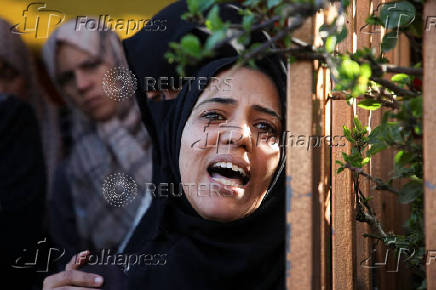 Palestinians mourn loved ones killed in Israeli strikes, in Khan Younis in the southern Gaza Strip