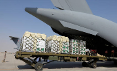 Qatari aid being loaded onto a military cargo plane headed to Syria through Turkey