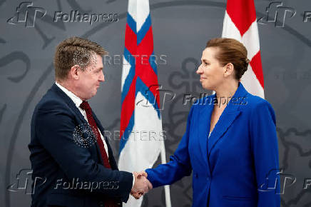 Denmark's Prime Minister Mette Frederiksen and the Faroese Prime Minister Aksel V. Johannesen sign a joint request to the Danish Supreme Court, in Prime Minister's Office, in Copenhagen