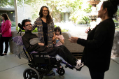 First-time voter Yeshua Loya with his sister Hadassah and mom Mariana Sanchez speak with Monica Murray, Supervisor for the Special Election Board, in Scottsdale