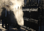 Commuters walk during the rush hour on a cold morning ahead of Ireland's general election, in Dublin