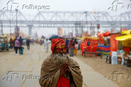 A Sadhu or Hindu holy man walks along a path inside the makeshift tent city during the 