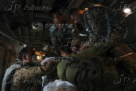 Members of Jordanian armed forces prepare to air drop aid parcels over Gaza