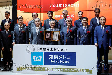 Akiyoshi Yamamura, President of Tokyo Metro, holds an IPO certificate at a ceremony to mark the company's debut on the Tokyo Stock Exchange in Tokyo