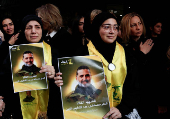 Mourners react during the funeral of Hezbollah commander Al-Hajj Mustafa Abdel Latif al-Zein, after a ceasefire agreement between Hezbollah and Israel took effect, in Beirut