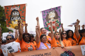 Demonstrators attend a walk, aimed to call for an end of violence against girls and women, in Copacabana beach in Rio de Janeiro