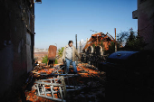 A woman inspects the damage caused by projectiles fired from Lebanon, following the ceasefire between Israel and Iran-backed group Hezbollah, in Metula