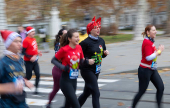 Runners wearing Santa Claus-themed outfits take part in the 