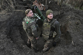 Policemen of the 'Khyzhak' Brigade prepare to fire a mortar towards Russian troops at their position in a front line near the town of Toretsk