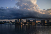 FILE PHOTO: City skyline and harbour are seen at sunrise from a quarantine bus window during the Tokyo 2020 Olympic Games in Tokyo, Japan