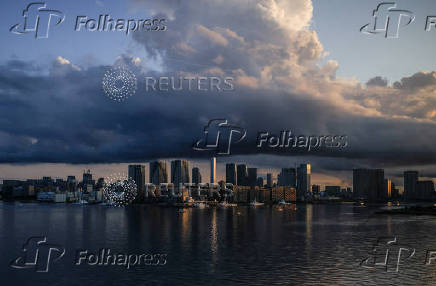 FILE PHOTO: City skyline and harbour are seen at sunrise from a quarantine bus window during the Tokyo 2020 Olympic Games in Tokyo, Japan