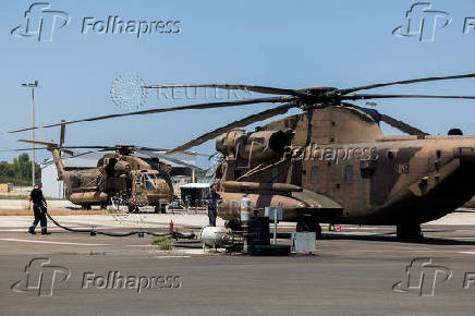 Ground crew works next to military helicopter in Tel Nof military base in central Israel