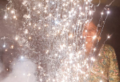 FILE PHOTO: A woman watches as firecrackers burn during Diwali, the Hindu festival of lights, in Mumbai