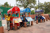 Ice cream vendors wait for customers on a hot summer day in New Delhi