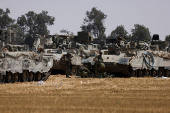 Israeli military vehicles are parked near the Israel-Gaza border