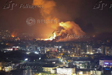 Smoke billows over Beirut's southern suburbs, as seen from Sin El Fil