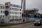 Car logos are displayed on the exterior of a car dealership