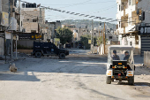 Palestinian security forces patrol amid clashes with militants at the camp in Jenin