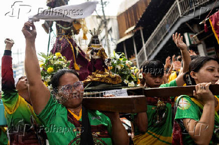 Filipino Catholics participate in the parade of Black Nazarene replicas