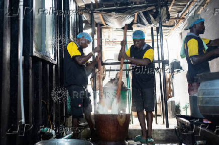 Cooks prepare food inside the kitchen of a local restaurant in Lagos