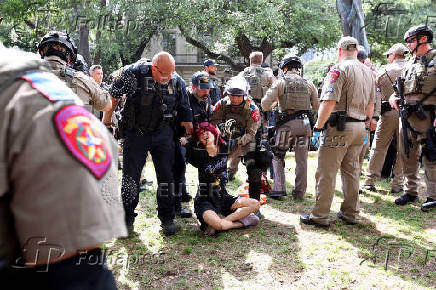 Law enforcement carry a pro-Palestinian protester at the University of Texas