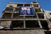 A banner that reads 'Made in USA' hangs on a damaged building in the Chiyah district of Beirut's southern suburbs