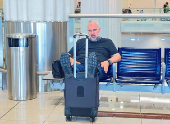A passenger sleeps as he waits for his flight at the Dubai International Airport