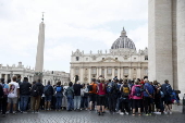 Tourists queue to visit St. Peter's Basilica