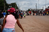 Venezuelans queue to enter a shelter after leaving Venezuela, in Pacaraima