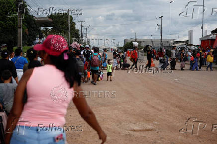 Venezuelans queue to enter a shelter after leaving Venezuela, in Pacaraima