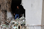 A resident of Baalbek, Hamza al Outa, stands in his destroyed kitchen, in Baalbek