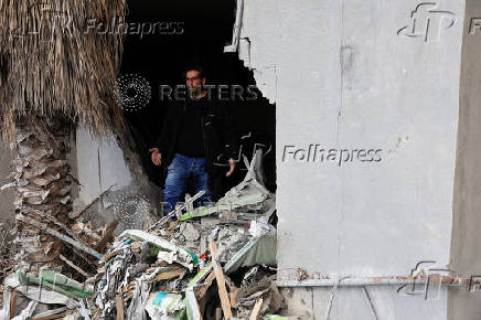 A resident of Baalbek, Hamza al Outa, stands in his destroyed kitchen, in Baalbek