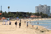 People relax on Melbourne St Kilda beach