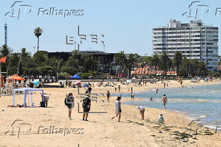 People relax on Melbourne St Kilda beach