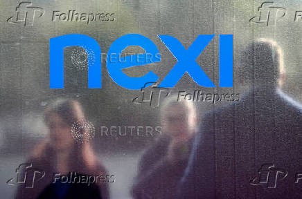 FILE PHOTO: People stand outside the Italian payments group Nexi's headquarters in Milan in Milan
