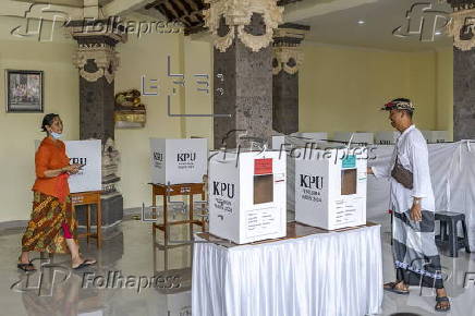 Voters cast their ballots in regional government elections in Indonesia