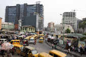 Commercial buses queue for passengers on Broad Street in Lagos