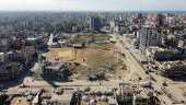 A drone view shows damaged and destroyed buildings as displaced Palestinians shelter in tents, following a ceasefire between Israel and Hamas, in Gaza City