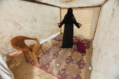 A woman stands at a tent set up for displaced Palestinians amid fears of an Israeli ground offensive on Rafah, in Deir Al-Balah in the central Gaza