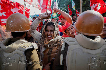 Farmers from the northern state of Uttar Pradesh shout slogans as they protest to demand better compensation for their land, in Noida