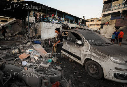 Palestinians gather at a UN school sheltering displaced people, following an Israeli strike, amid Israel-Hamas conflict, in Gaza City