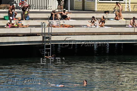 People relax on Melbourne St Kilda beach