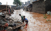 Residents recover their belongings after the Nairobi river burst its banks in the Mathare Valley settlement in Nairobi